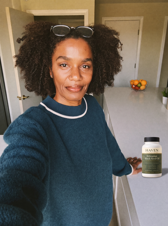 Customer with Haven Black Seed Oil on her kitchen counter