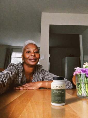 Customer with Haven Black Seed Oil at her table
